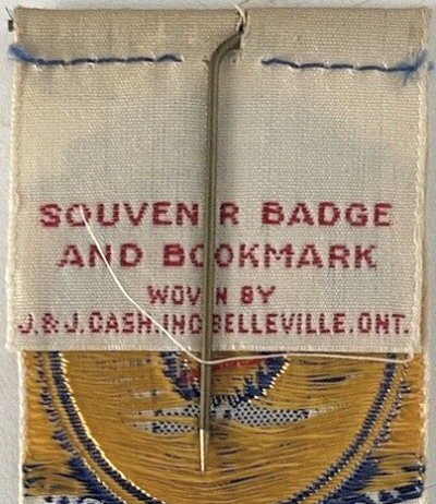 J & J Cash woven name on the reverse top turnover of this bookmark