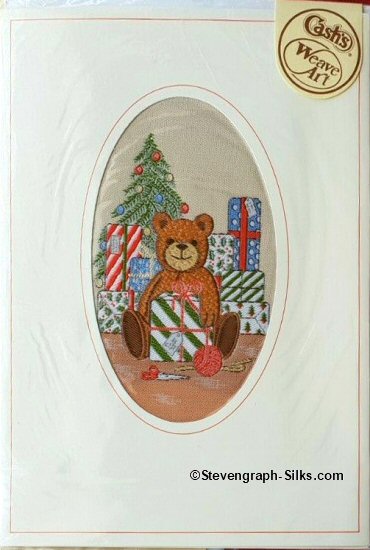 J & J Cash woven card, with no title words, but image of a Teddy bear with presents