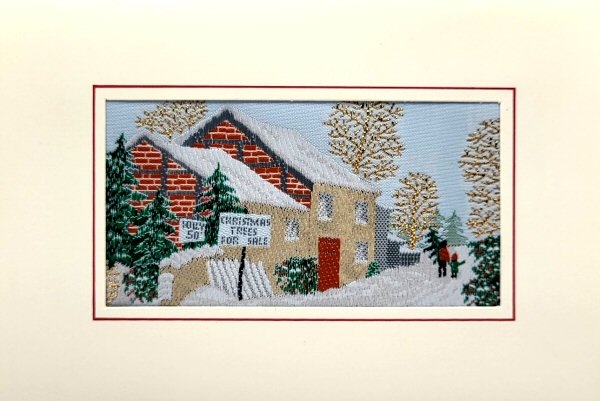 J & J Cash woven Christmas card, with words, Christmas trees for sale, on sign outside a cottage, with snow scene