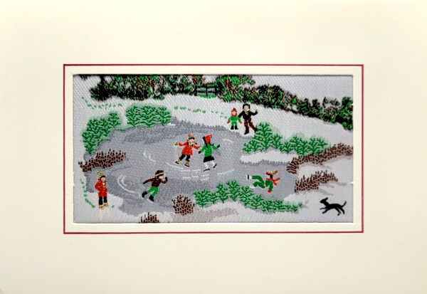 J & J Cash woven Christmas card, with no words, just image of a frozen pond with ice skaters