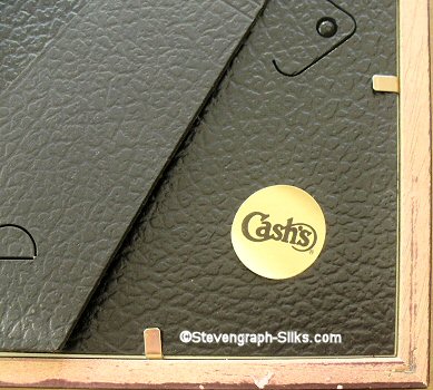 close up view of the round adhesive label found on these framed greetings cards, with CASH'S name
