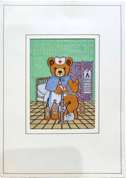 J & J Cash woven card, with no woven words, just image of a cuddly bear dressed up as a nurse