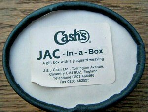 underside view of oval JAC-in-a-Box with J & J Cash printed label