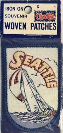 J & J Cash woven saw-on label with words: Seattle, with yacht
