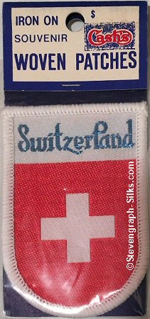 J & J Cash woven saw-on label with title word: Switzerland, and the national flag
