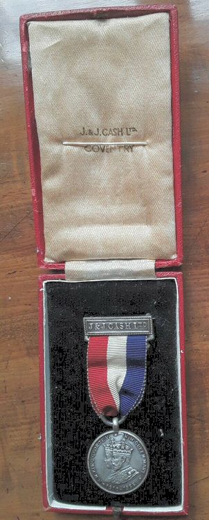 view of J & J Cash George V Jubilee medal with ribbon and in original case