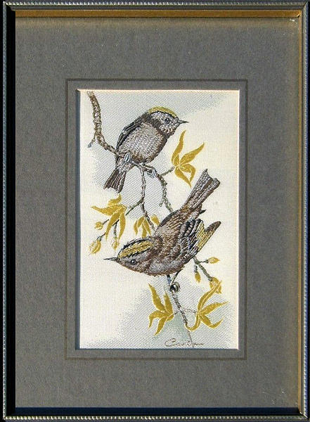 J & J Cash woven picture of a bird, with no words, but image of a pair of Gold Crest