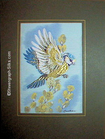 J & J Cash woven picture of a bird, with no words, but image of a Blue tit in flight