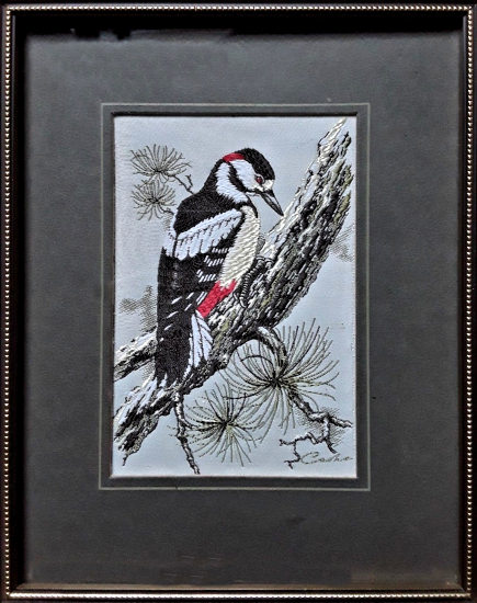 J & J Cash woven picture of a bird, with no words, but image of a Great Spotted Woodpecker