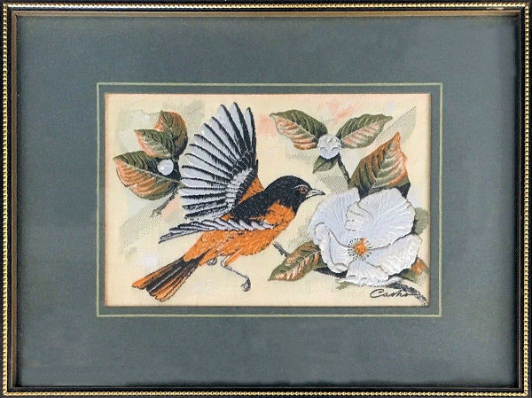 J & J Cash woven picture of a bird, with no words, but image of a Baltimore Oriole