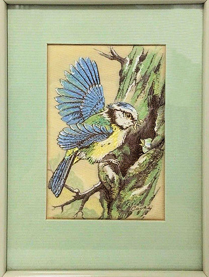 J & J Cash woven picture of a Blue tit, feeding a baby bird in hole in tree