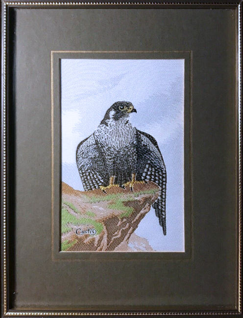 J & J Cash woven picture of a Peregrine Falcon stood on rock outcrop