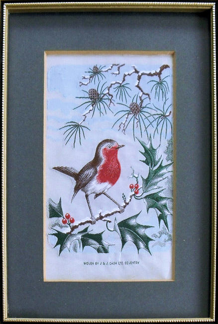 J & J Cash woven picture of a winter scene with a Robin on a snow covered holly branch and fir tree branch behind