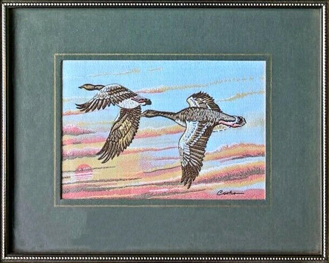 J & J Cash woven picture of two geese, with no words, but image of Greylag Geese