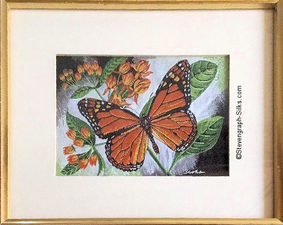 J & J Cash woven picture with no words, but image of a Monarch butterfly & orange flowers