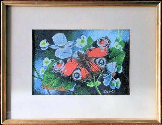 J & J Cash woven picture with no words, but image of a Peacock butterfly & blue flowers