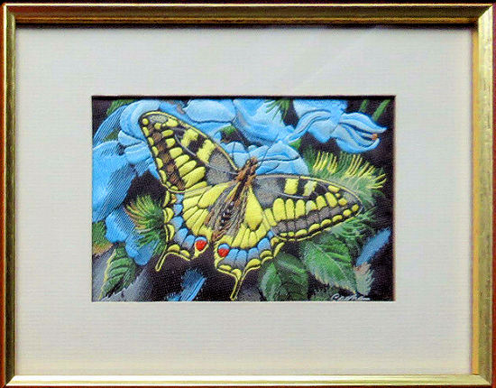 J & J Cash woven picture with no words, but image of a Swallowtail butterfly & blue flowers