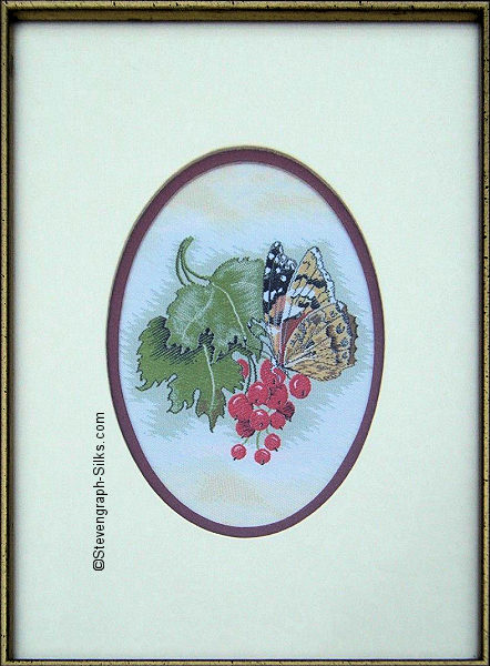 J & J Cash woven picture with no words, but image of a Painted Lady butterfly & berries