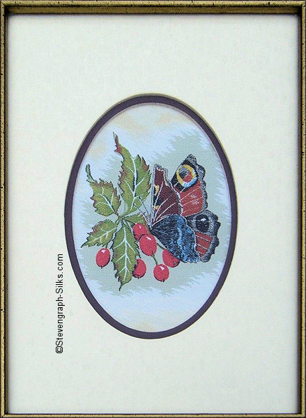 J & J Cash woven picture with no words, but image of a Peacock butterfly & Hawthorn berries
