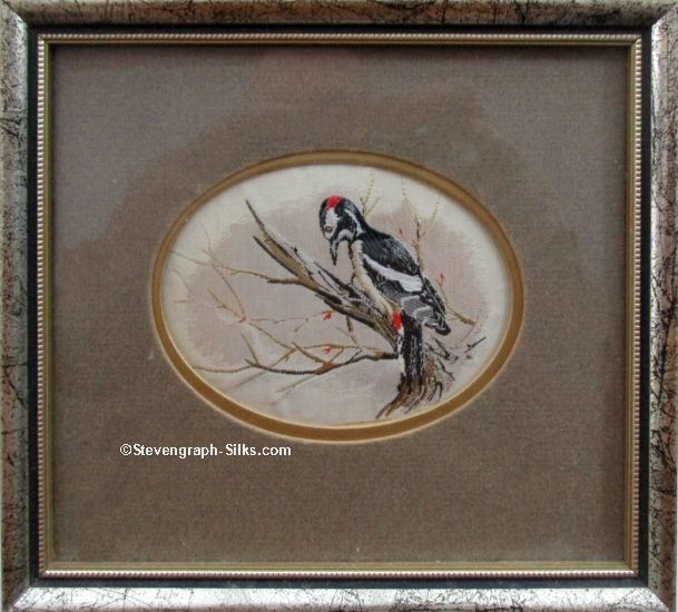 Framed woven picture of a Woodpacker on a dead tree stump