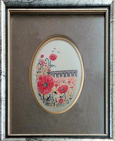 Framed woven picture of a Poppy flower