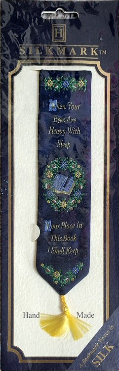 woven bookmark with words, When your eyes are heavy with sleep, Your place in this book I shall keep, and image of an open book