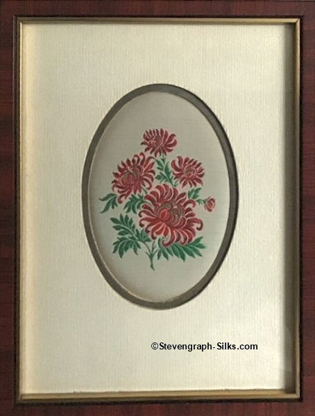 Framed woven picture of a group of red flowers