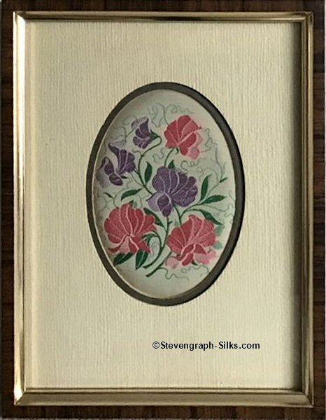 Framed woven picture of a group of pink & blue sweetpea flowers
