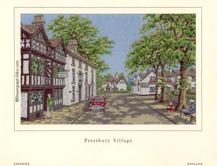 View of village main street, with people and red mini-car outside bank