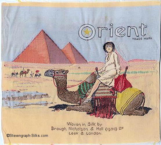 silk picture, with title of Orient - being a trade mark name - with image of egyptian pyramids, and a camel with a lady riding on its back