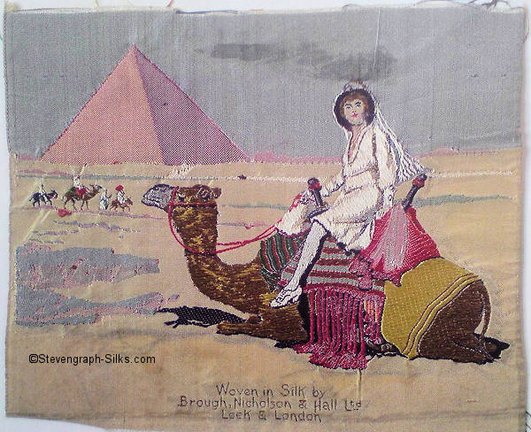 silk picture, with title of Orient - being a trade mark name - with image of egyptian pyramids, and a camel with a lady riding on its back