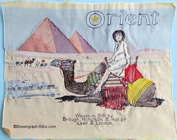 silk picture, with title of Orient - being a trade mark name - with image of egyptian pyramids, and a camel with a lady riding on its back