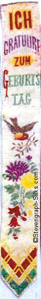 Silk bookmark with title in greman words and image of bird and flowers