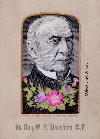 Image of William Gladstone, M.P., looking half right, with flowers across his jacket - the central flower being a wild rose
