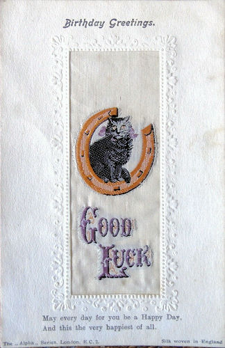 Stevens Alpha series postcard with image of a cat sat on a horse shoe