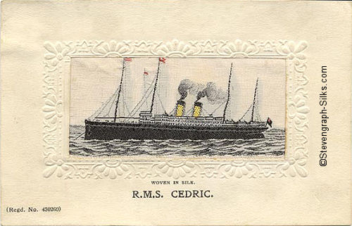 Ocean liner at anchor facing left, with four masts and two funnels