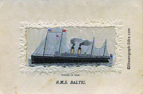Ocean liner at anchor with two funnels and four masts.