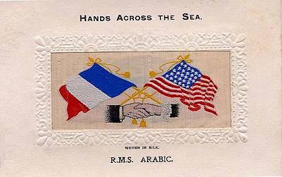 image of shaking hands, flags and tassles